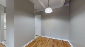 Denver apartment for rent - A room with a wooden floor and a white door.