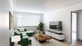 Denver apartment for rent - A living room with a green couch, a wooden coffee table, and a flat screen TV mounted on the wall.