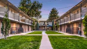 Englewood apartment for rent - A courtyard surrounded by apartment buildings with a walkway in the middle.