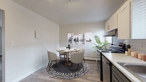 Englewood apartment for rent - A kitchen with a table and chairs in the middle of the room.