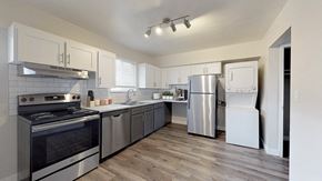 Englewood apartment for rent - A modern kitchen with stainless steel appliances and wooden floors.
