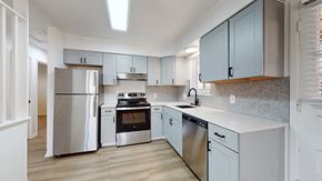 Lakewood apartment for rent - A kitchen with stainless steel appliances and light wood flooring.