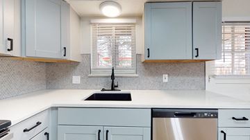 Lakewood apartment for rent - A kitchen with a stainless steel dishwasher and a black faucet.