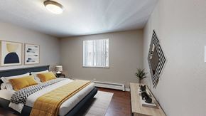 Denver apartment for rent - A bedroom with a bed, nightstand, and a window with blinds.