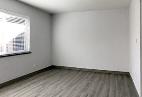 Denver apartment for rent - A room with a window and wooden flooring.