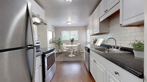 Westminster apartment for rent - A modern kitchen with a stainless steel refrigerator and white cabinets.