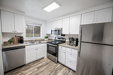 Denver apartment for rent - A kitchen with white cabinets and stainless steel appliances.
