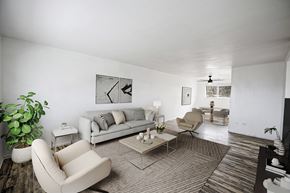 Denver apartment for rent - A living room with a couch, chair, and potted plant.