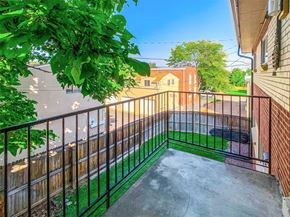 Lakewood apartment for rent - A balcony with a black railing and a green lawn.