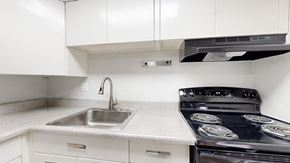 Lakewood apartment for rent - A modern kitchen with a black stove top oven.