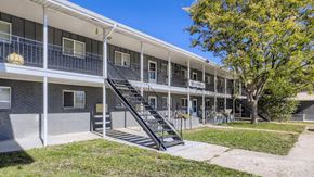 Arvada apartment for rent - A multi-story apartment building with a staircase leading to the second floor.