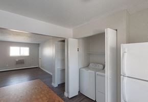 Arvada apartment for rent - A white bedroom with a washer and dryer built into the closet.