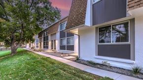Littleton townhouse for rent - A modern apartment building with a tree in front.