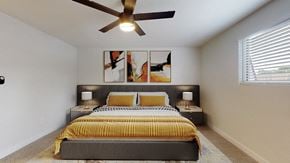 Littleton townhouse for rent - A bedroom with a bed, two lamps, and a ceiling fan.