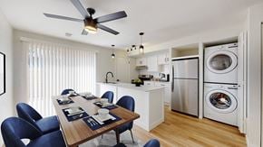 Littleton townhouse for rent - A modern kitchen with a dining table set for six.