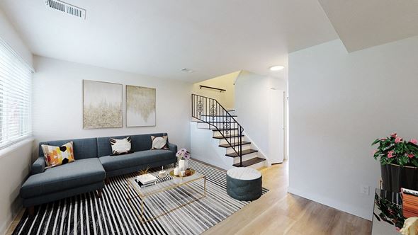 Littleton townhouse for rent - A living room with a blue couch and a glass coffee table.