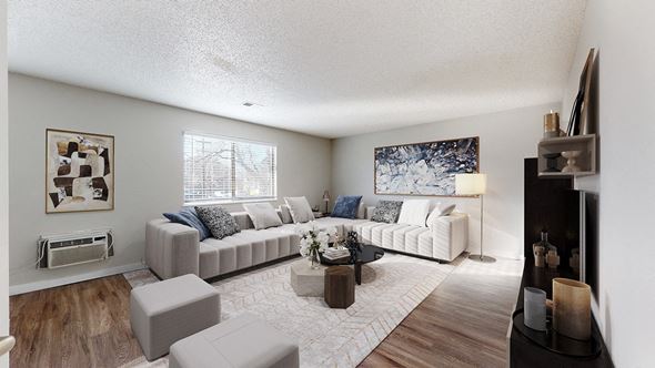 Arvada apartment for rent - A living room with a grey couch and a coffee table.
