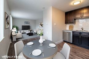 Denver apartment for rent - A modern dining room with a grey table and white chairs.
