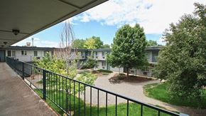 Lakewood apartment for rent - A view of a courtyard from a covered walkway.