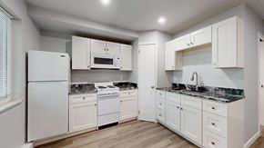 Lakewood apartment for rent - A kitchen with white appliances and cabinets.