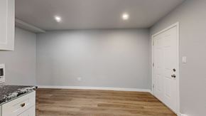 Lakewood apartment for rent - A kitchen with a white door and a marble countertop.