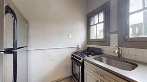 Denver apartment for rent - A kitchen with a stove, sink, and refrigerator.