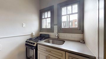 Denver apartment for rent - A kitchen with a stove, sink and window.