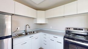 Lakewood apartment for rent - A kitchen with white cabinets and a stainless steel refrigerator.