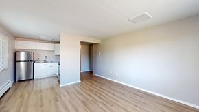 Lakewood apartment for rent - A kitchen with white cabinets and a stainless steel refrigerator.