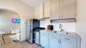 Denver apartment for rent - A kitchen with a refrigerator, sink, and cabinets.