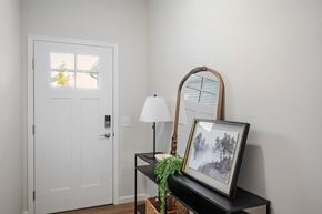 Brimfield apartment for rent - A white door with a window and a table with a lamp and a picture frame.