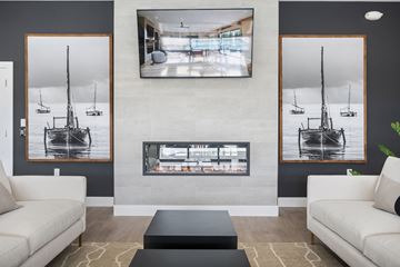 Perrysburg apartment for rent - A living room with a fireplace and a large painting above it.