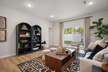 Stow townhouse for rent - A living room with a wooden coffee table and a large window with curtains.