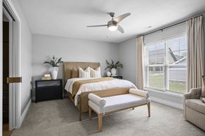 Strongsville apartment for rent - A bedroom with a large bed and a window with blinds.