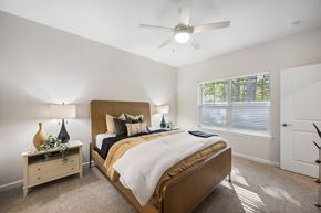 Brimfield apartment for rent - A bedroom with a bed, nightstand, and window.