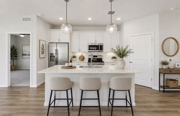 Medina apartment for rent - A modern kitchen with white cabinets and a central island.