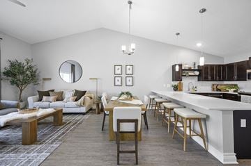 Strongsville apartment for rent - A modern kitchen and living room with a dining table and chairs.