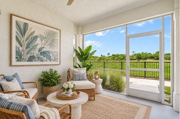 Port St Lucie apartment for rent - A living room with a large painting on the wall and a view of a green lawn outside.
