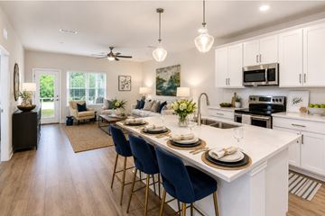 Pensacola apartment for rent - A kitchen with a dining table set for four.
