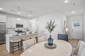 Hinckley apartment for rent - A kitchen with a table and chairs in the foreground.