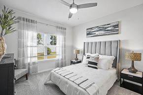 Hinckley apartment for rent - A bedroom with a large bed and a ceiling fan.