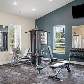 Hinckley apartment for rent - A gym with a variety of equipment including weights and weight machines.