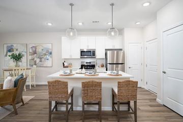 Milton apartment for rent - A modern kitchen with a dining table set for four.