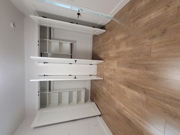 White Rock apartment for rent - A kitchen with a white cabinet and a wooden wall.