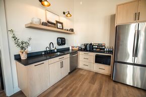 Salem apartment for rent - A modern kitchen with wooden cabinets and a stainless steel refrigerator.at Eastpark Apartment Homes, Salem