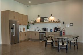 Salem apartment for rent - A modern kitchen with a refrigerator, sink, and dining table at Northplace Apartment Homes, Salem