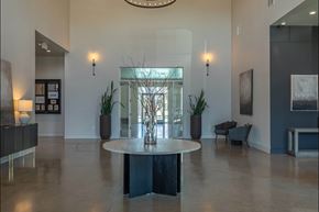 Salem apartment for rent - A large, round table sits in the middle of a spacious room with a glass wall behind it at Northplace Apartment Homes, Salem, OR