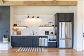 St Helens apartment for rent - A kitchen with a black fridge and a white sink at St Helens Place Apartment Homes, St Helens, OR