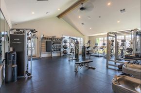 St Helens apartment for rent - A spacious gym with various exercise equipment and a bench at St Helens Place Apartment Homes, St Helens, 97051