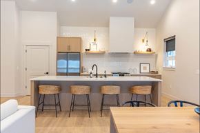 Pendleton apartment for rent - A kitchen with a white counter top and bar stools at Westgate Apartment Homes, Pendleton, OR, 97801